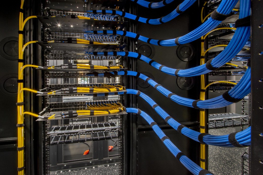 Structured copper and fiber cabling dressed in a telecommunications rack